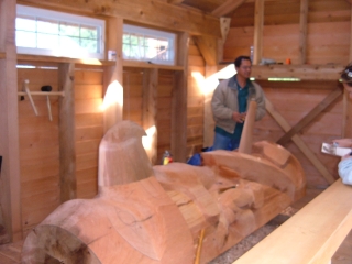 Carving a totem pole.